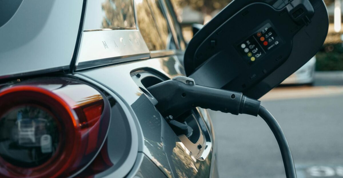 Close-up of an electric vehicle being charged highlighting modern clean energy technology