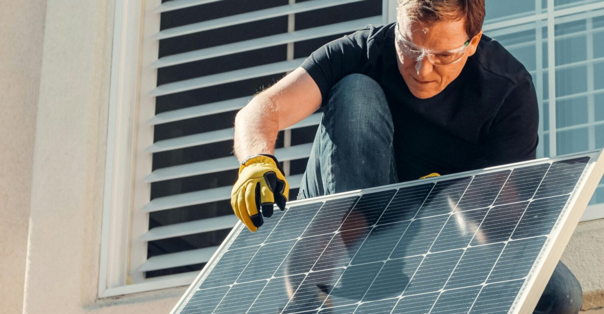 Solar technician installing a photovoltaic panel on a rooftop, promoting renewable energy.