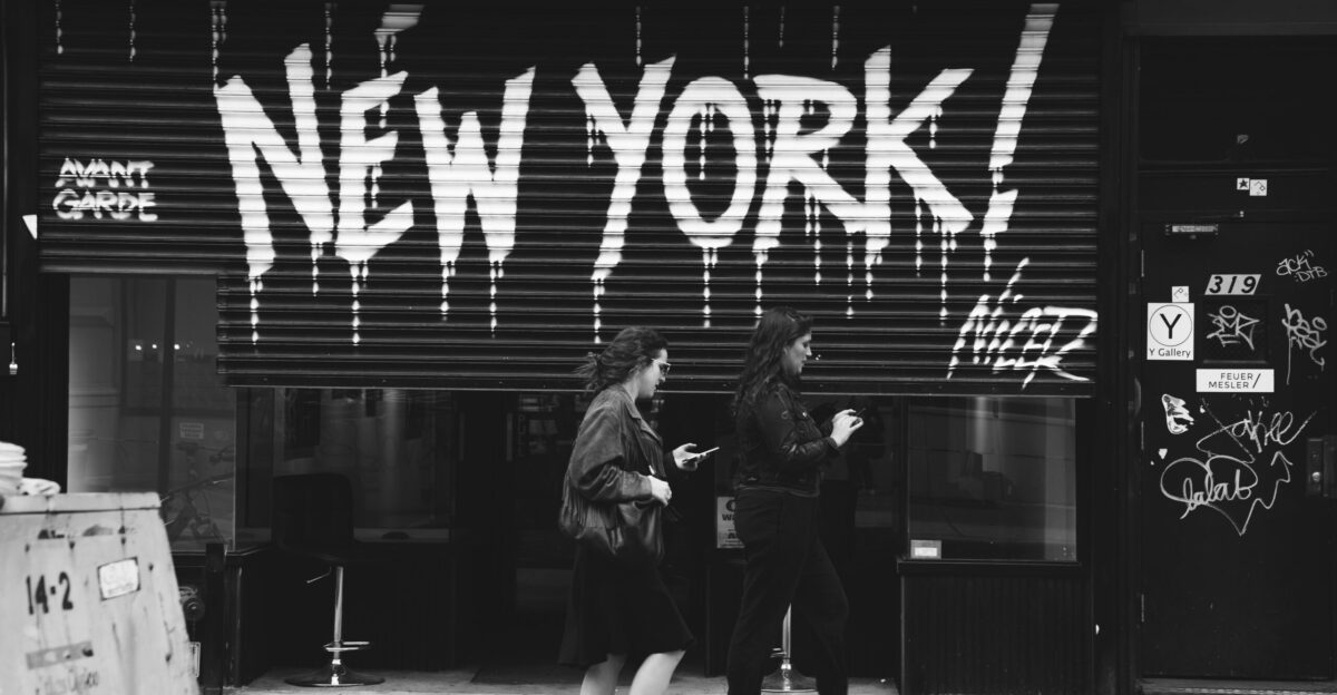 grayscale photography of two women walking