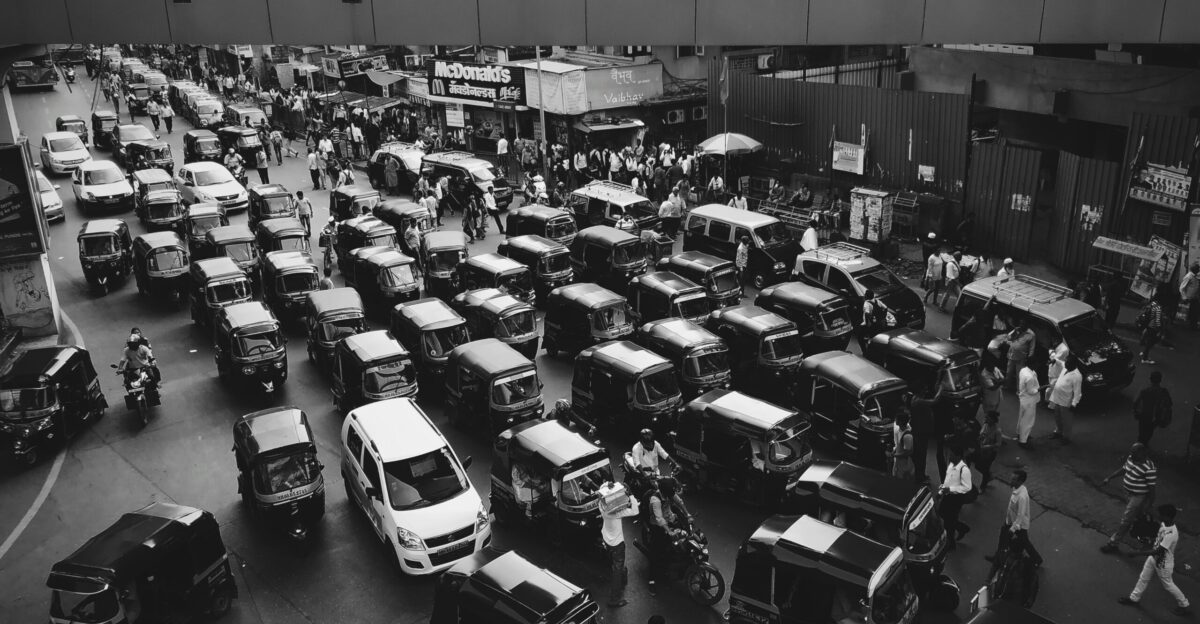 vehicles traveling on road grayscale photo