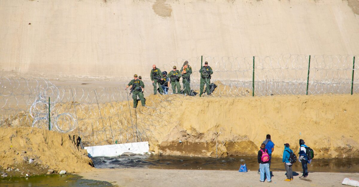 four person standing near monuntain