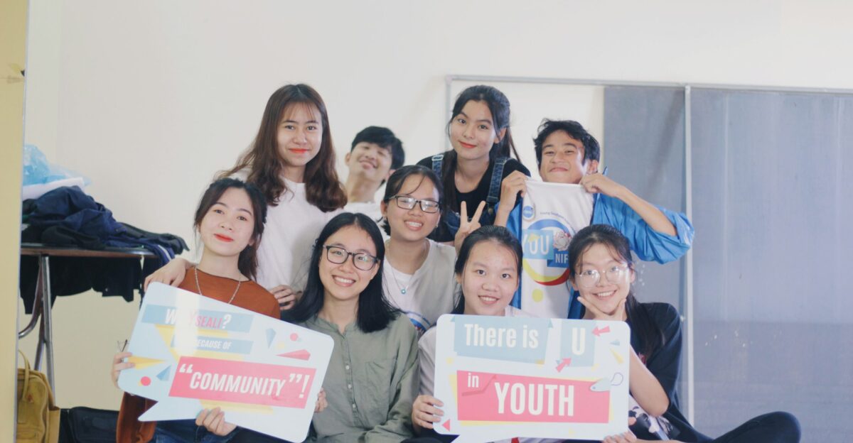 people holding banner taking pose