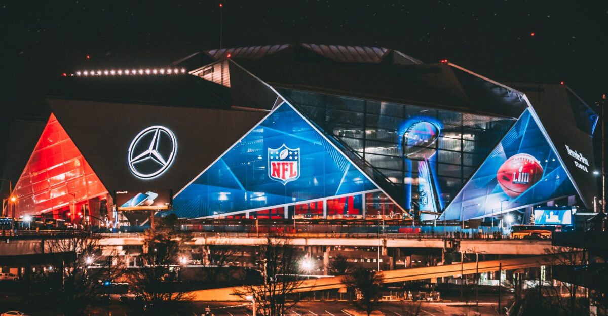 a stadium lit up at night with a lot of lights