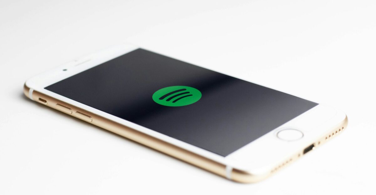 gold iPhone 7 displaying spotify logo