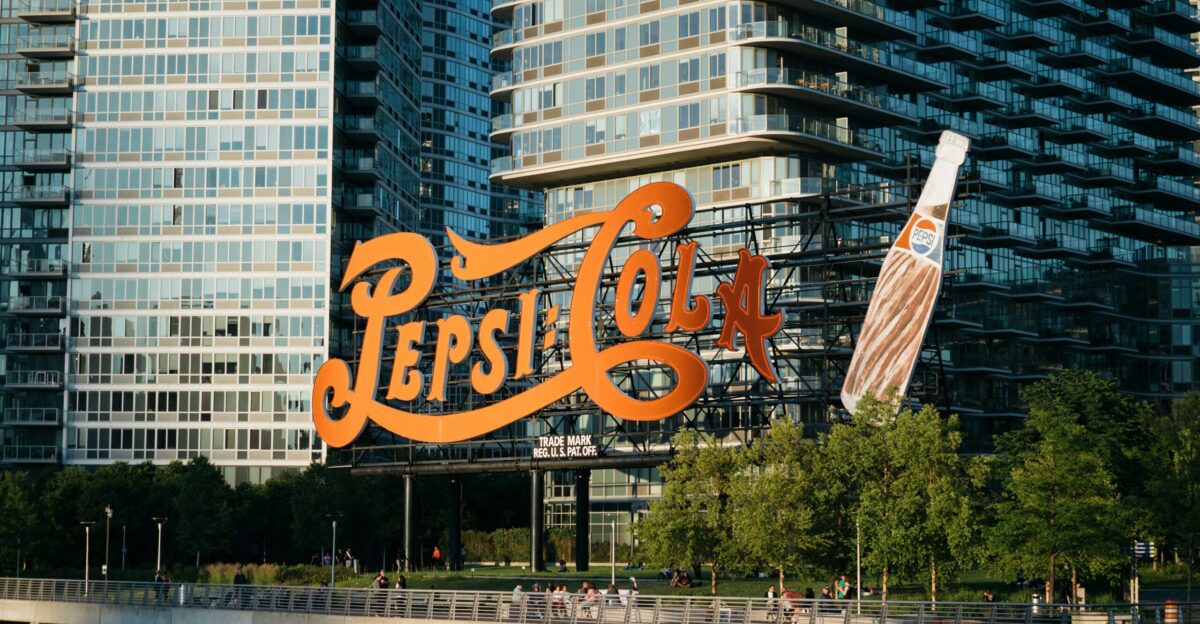 Pepsi-Cola signage near body of water