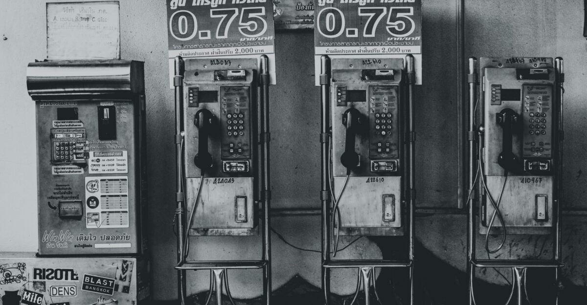 gray-scale photo of telephones
