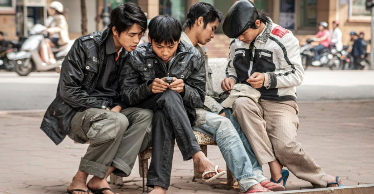 four men sitting bench