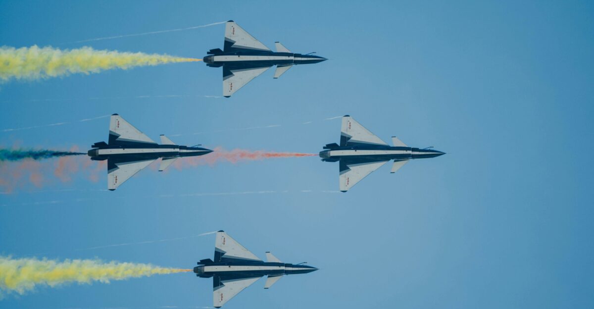 four fighter planes flying in the sky