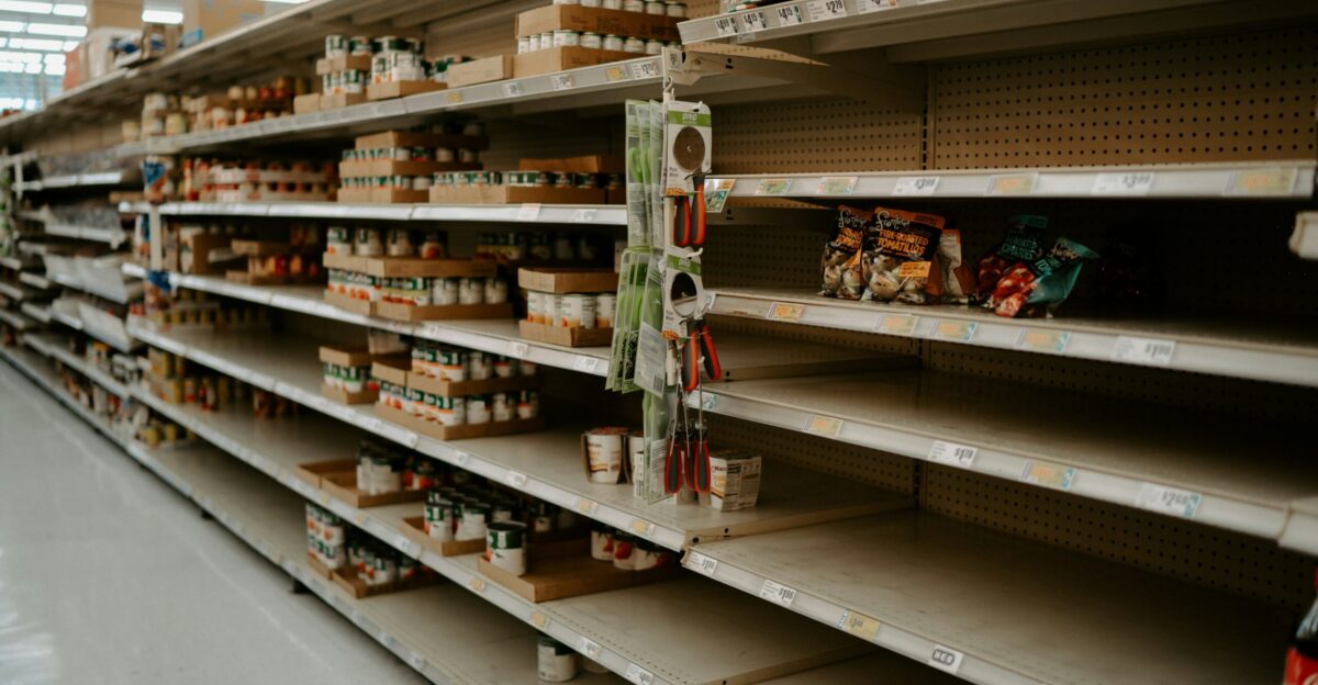 woman in white shirt standing on grocery store
