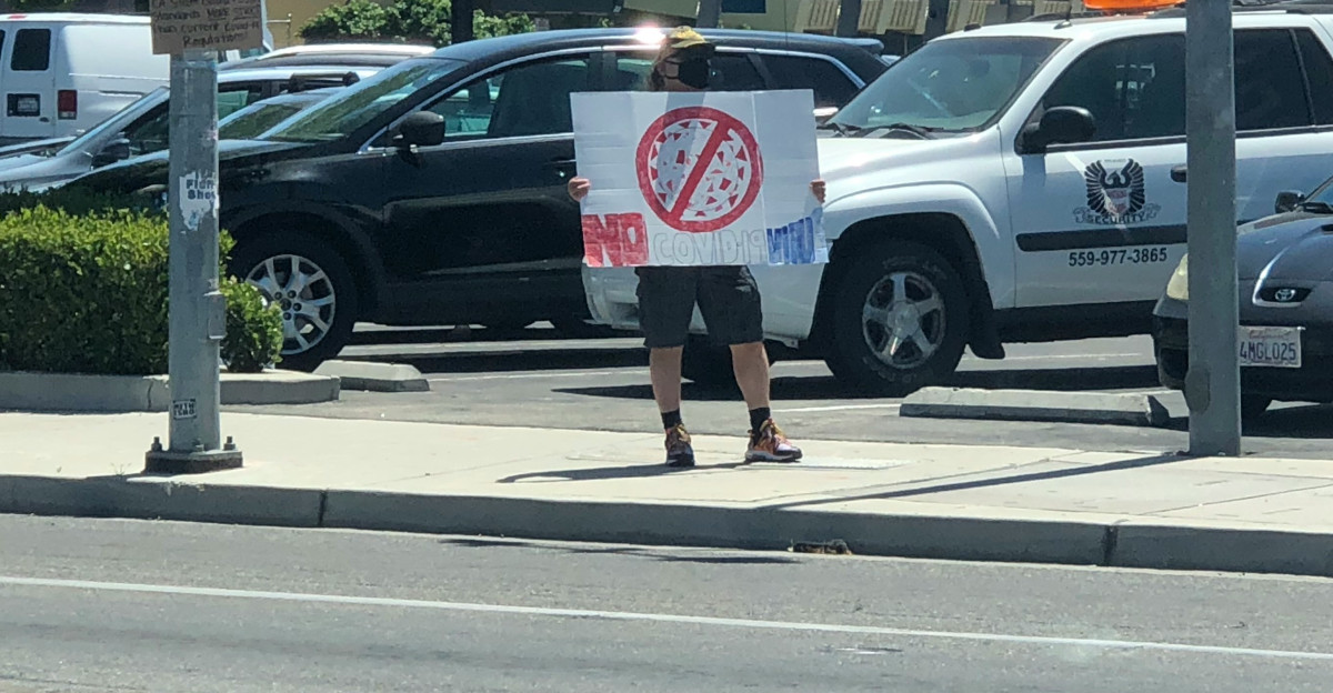 men standing on pedestrian lane during daytime