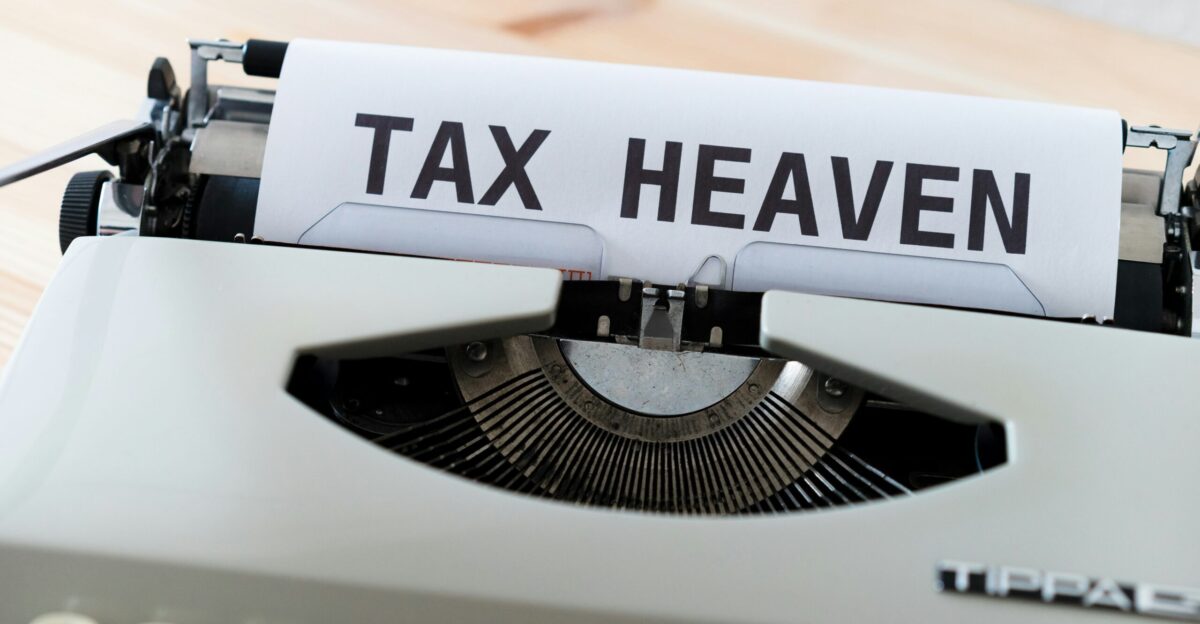 a close up of a typewriter with a tax heaven sign on it