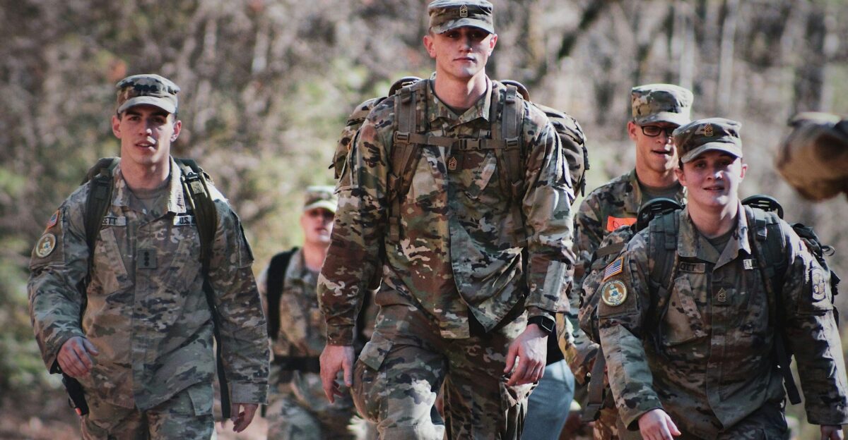 men in camouflage uniform standing on field during daytime