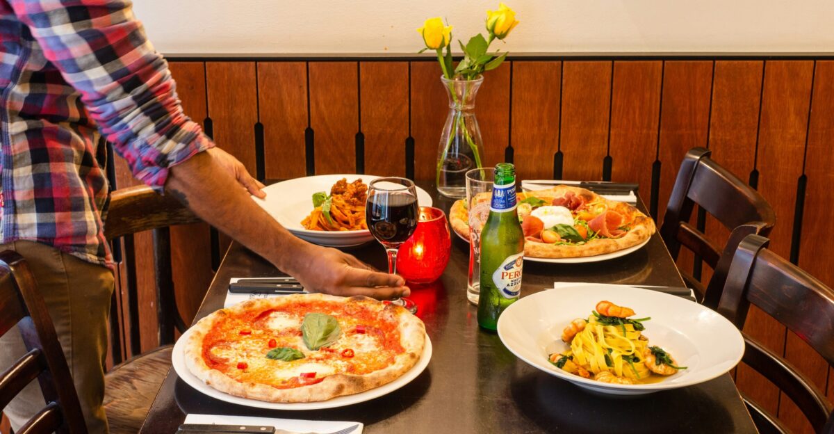 person holding plate with pizza