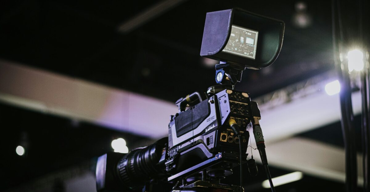 black video camera on black tripod