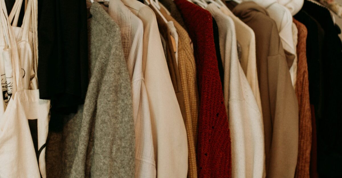 brown and white coat hanged on rack