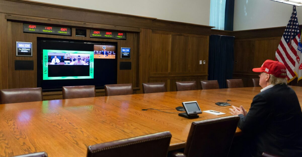 black flat screen tv turned on near brown wooden wall