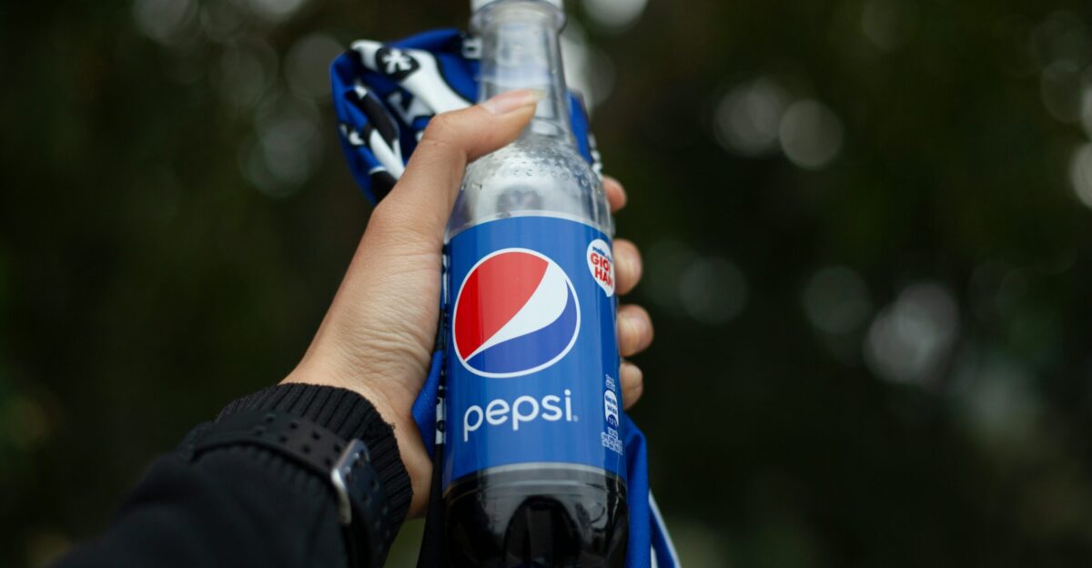 person holding pepsi plastic bottle