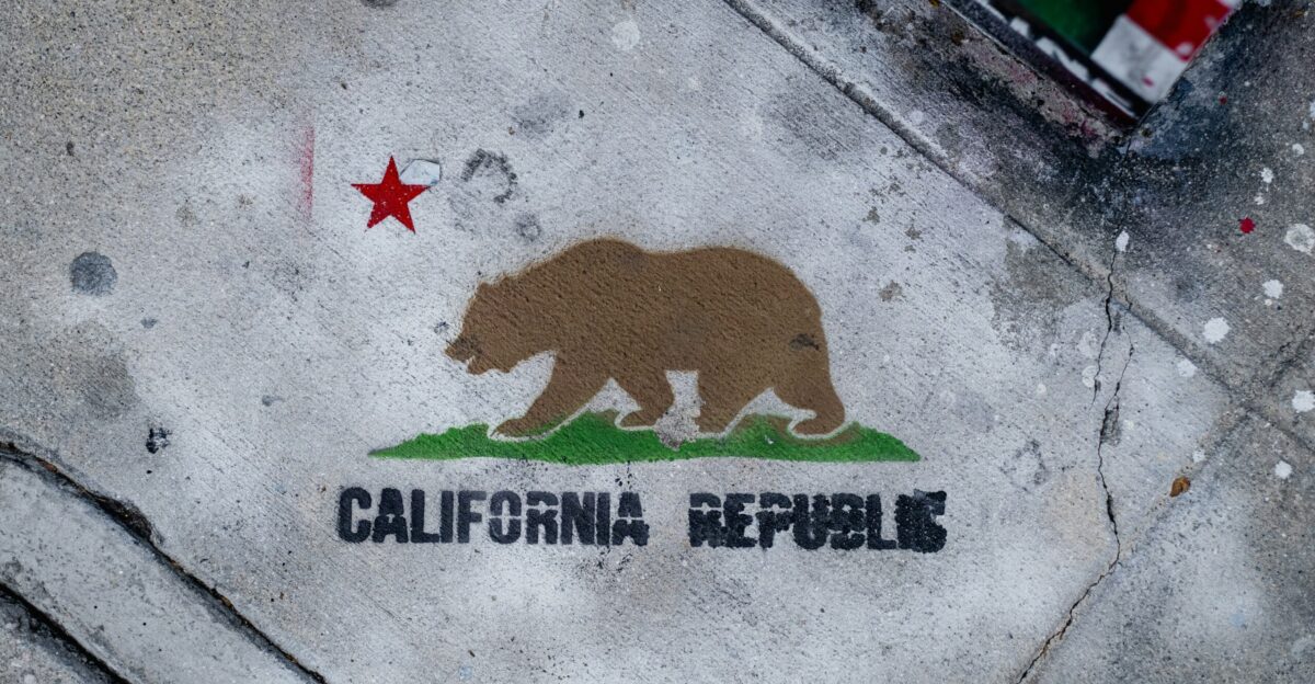 a sidewalk with a bear painted on it