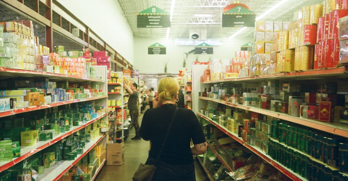 woman in black long sleeve shirt standing near white shelf