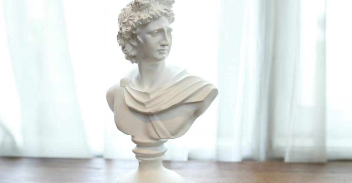 white ceramic statue on brown wooden table