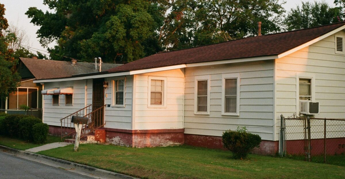 white and brown wooden house near green trees during daytime