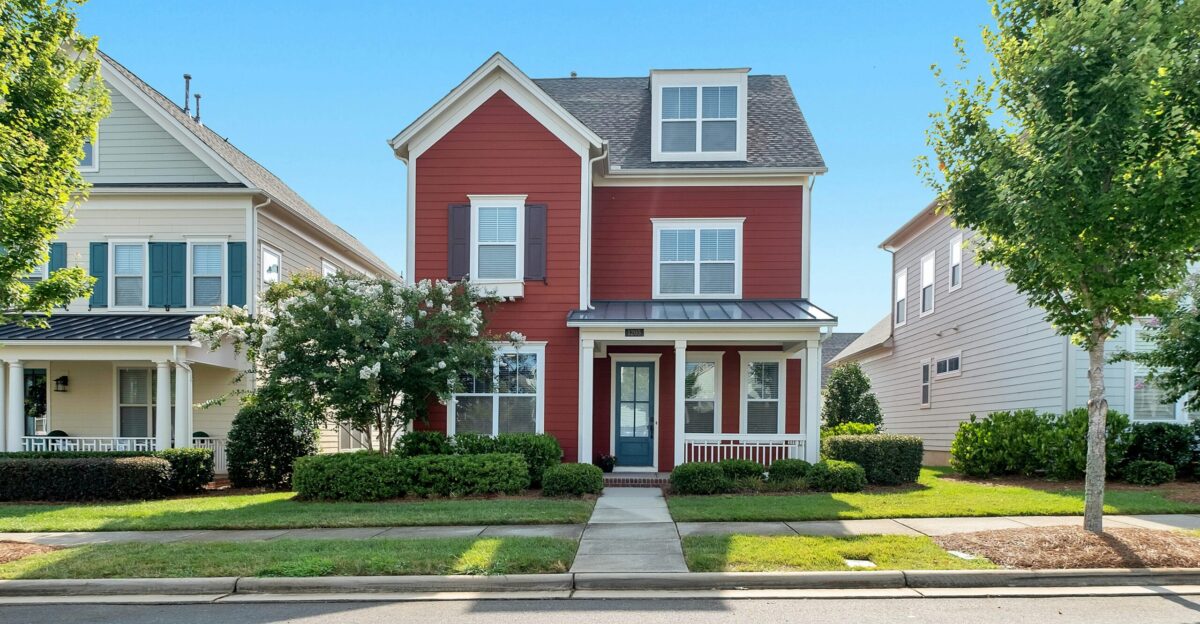 white and brown concrete house near green trees during daytime