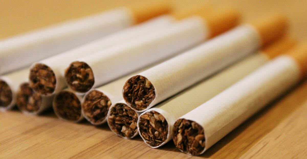 a group of cigarettes sitting on top of a wooden table