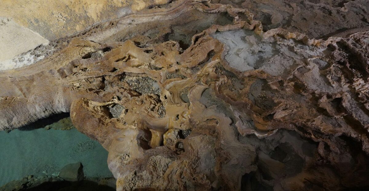 a cave filled with lots of rocks and water