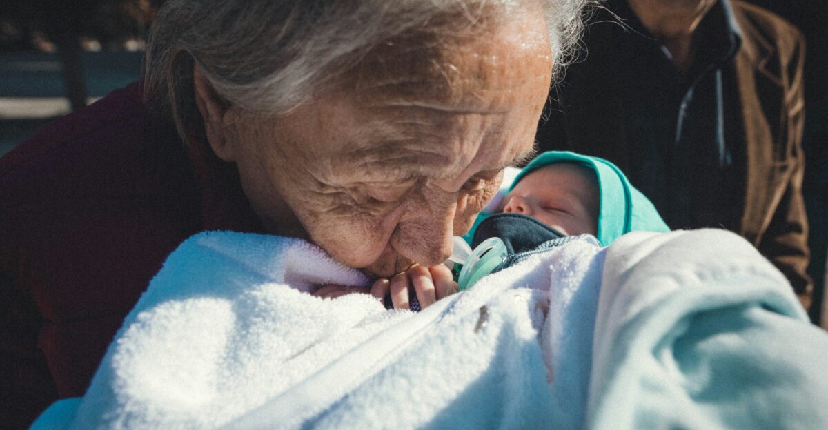 a woman holding a baby wrapped in a blanket