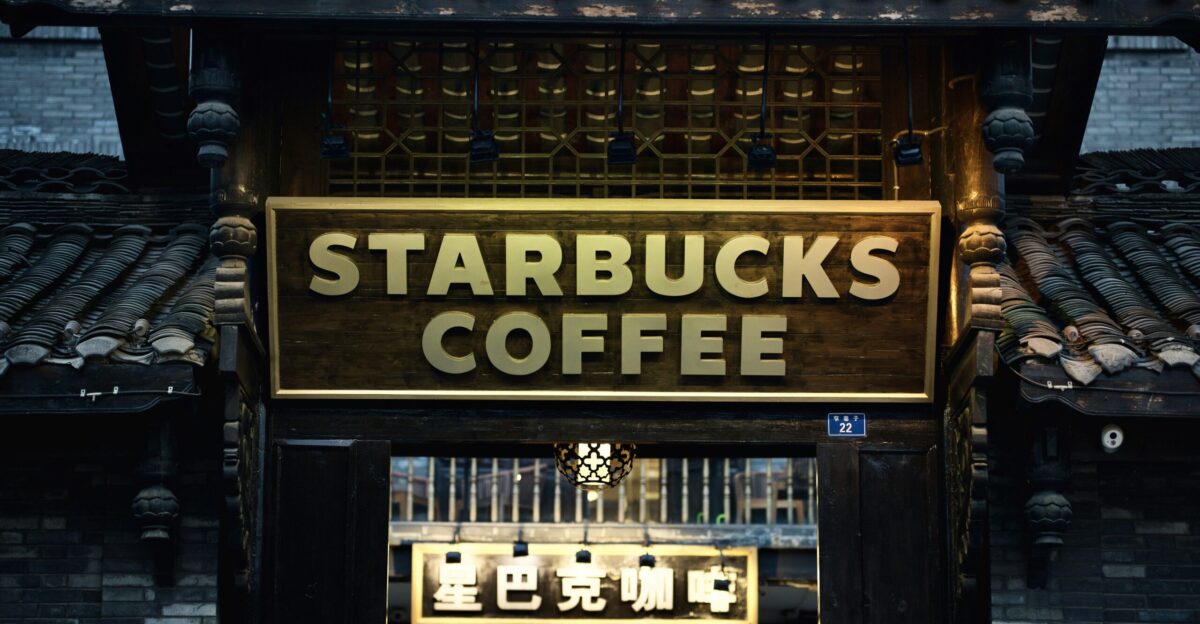 a starbucks coffee shop with a sign above it