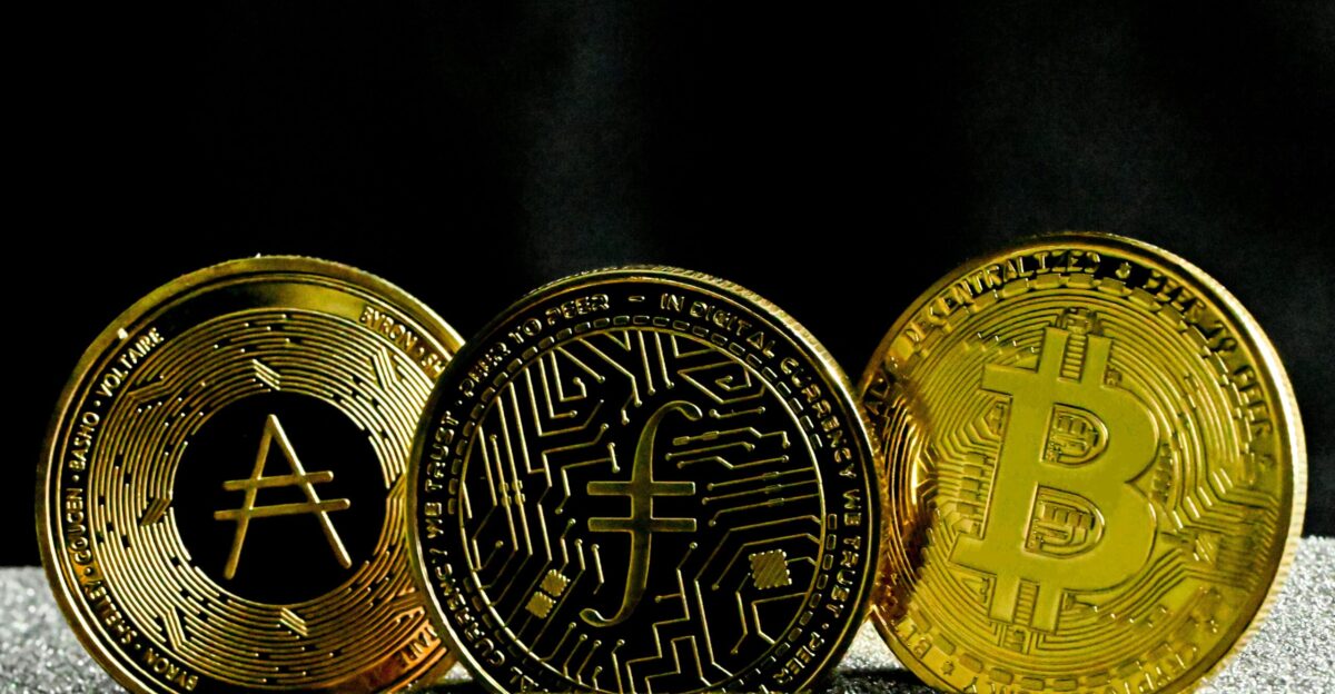 three gold bitcoins sitting next to each other