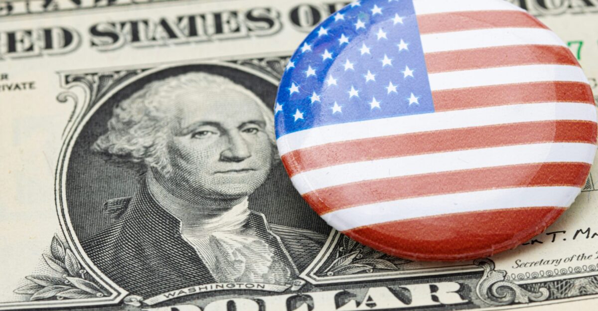 a button with the american flag on top of a one dollar bill