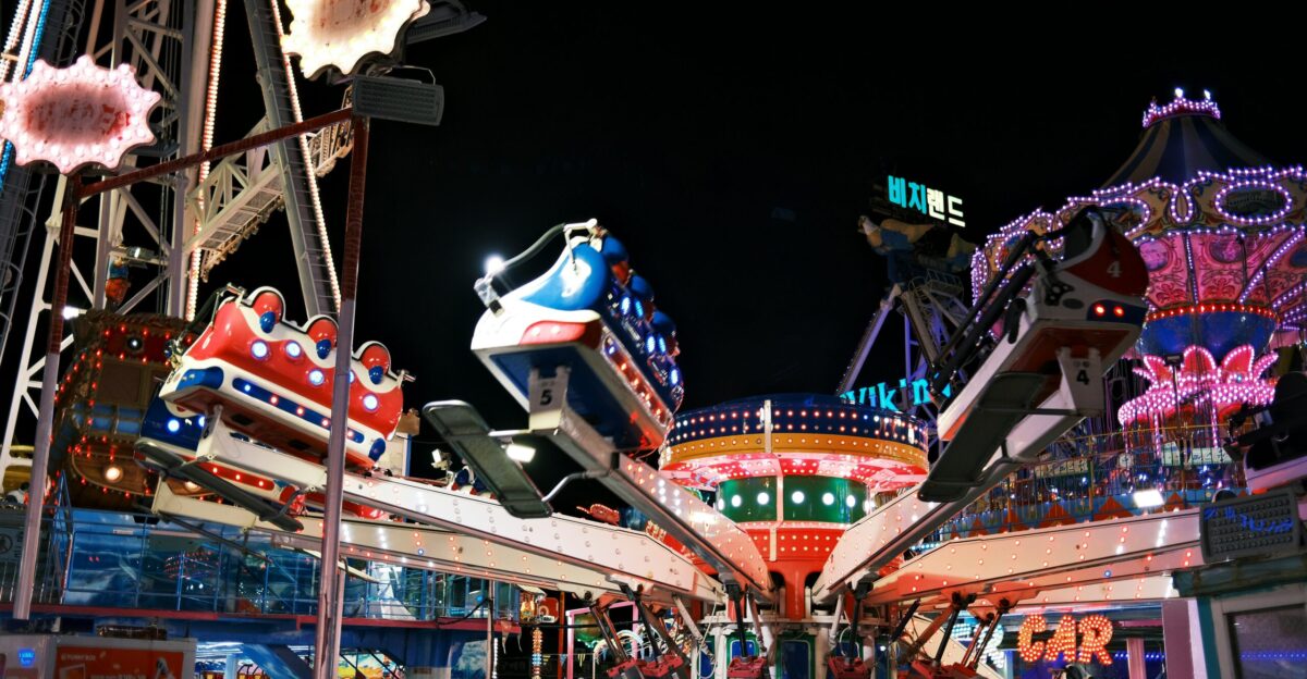 an amusement park at night with rides and rides