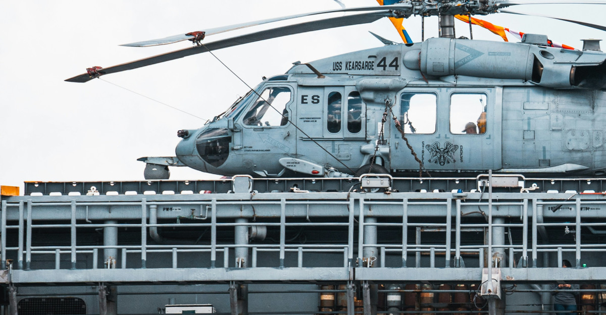 a helicopter sitting on top of an aircraft carrier