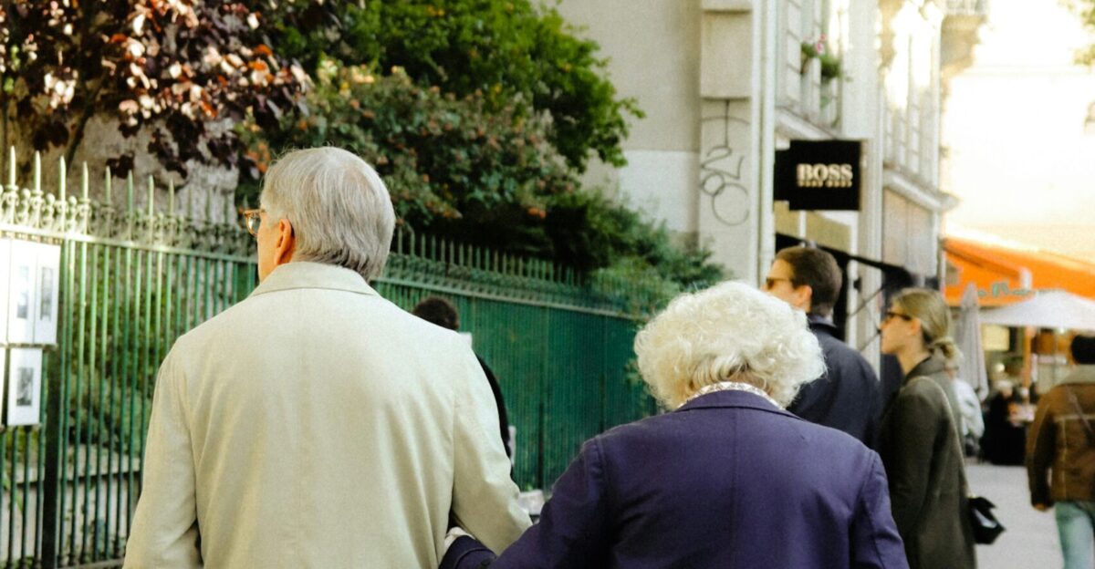 a couple of people walking down a sidewalk