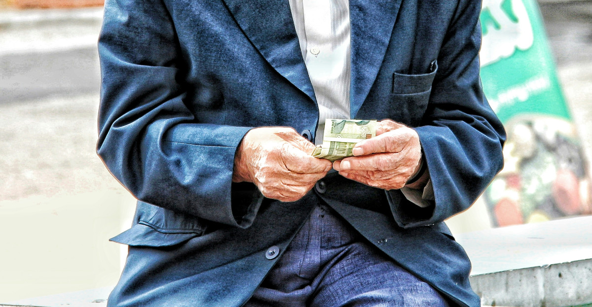 a man in a hat holding a glass of beer