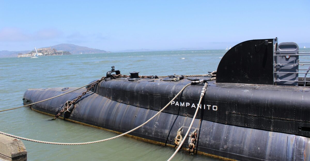 a large black submarine floating on top of a body of water