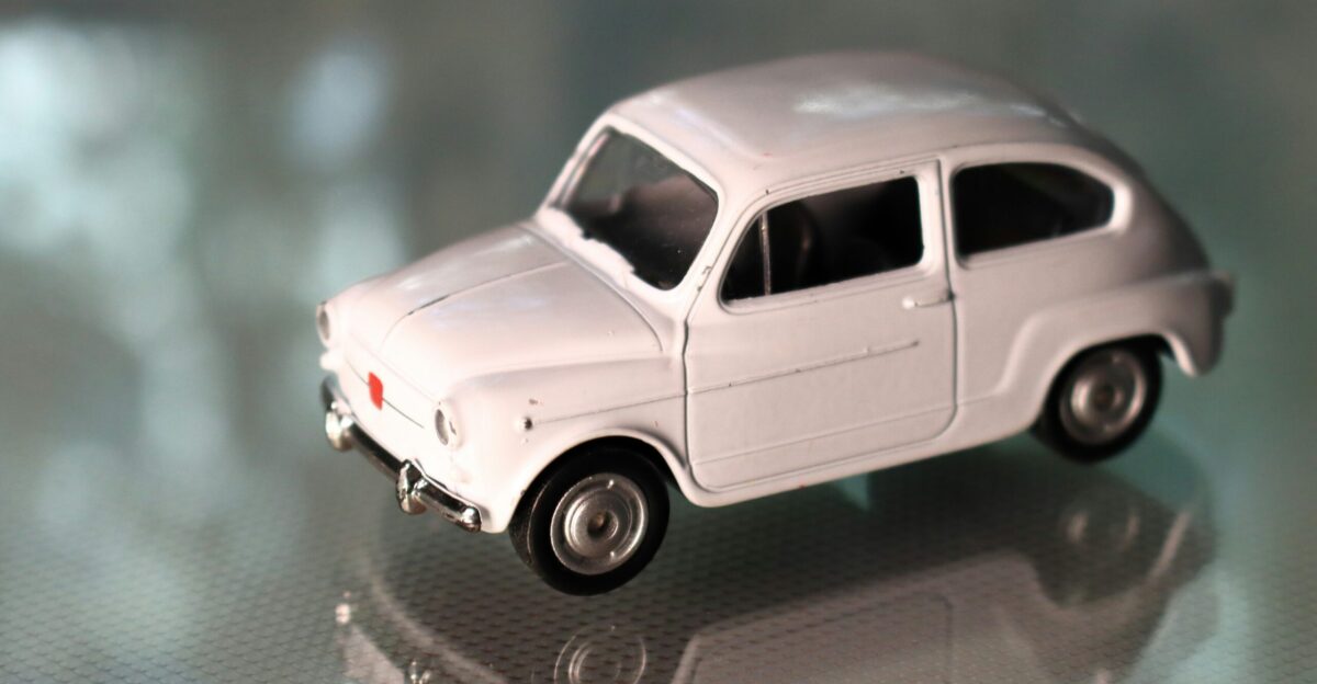 a white toy car sitting on top of a table