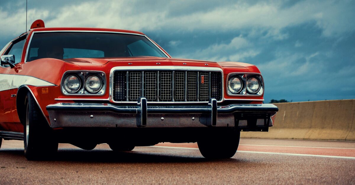 a red car is parked on the side of the road