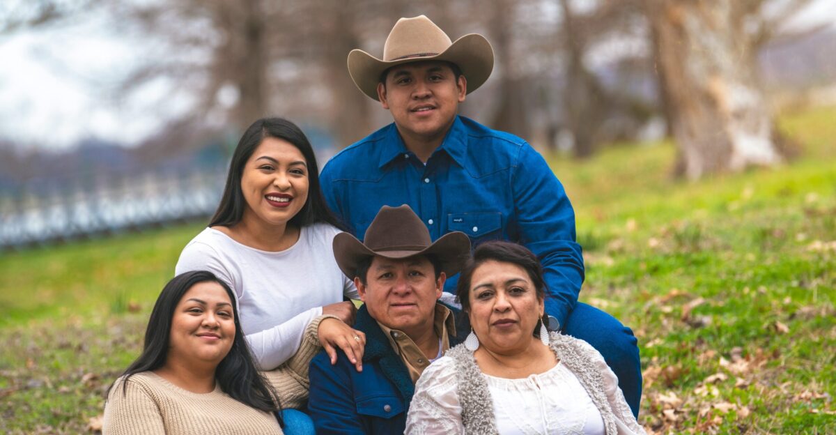 a group of people that are sitting in the grass