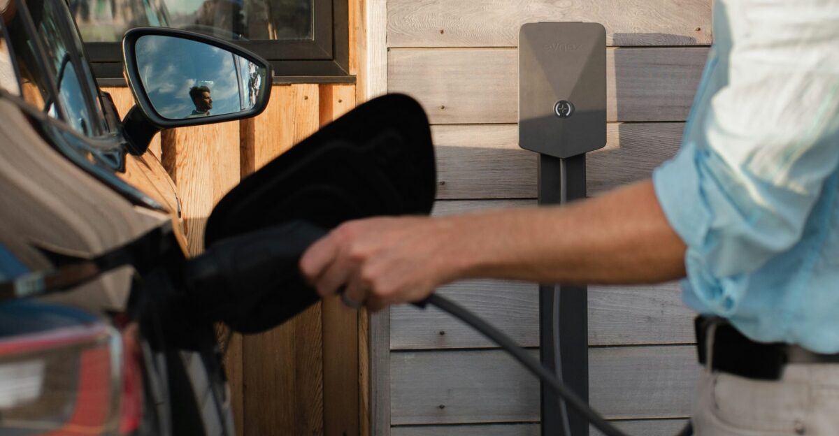 a man pumping gas into his car at a gas station