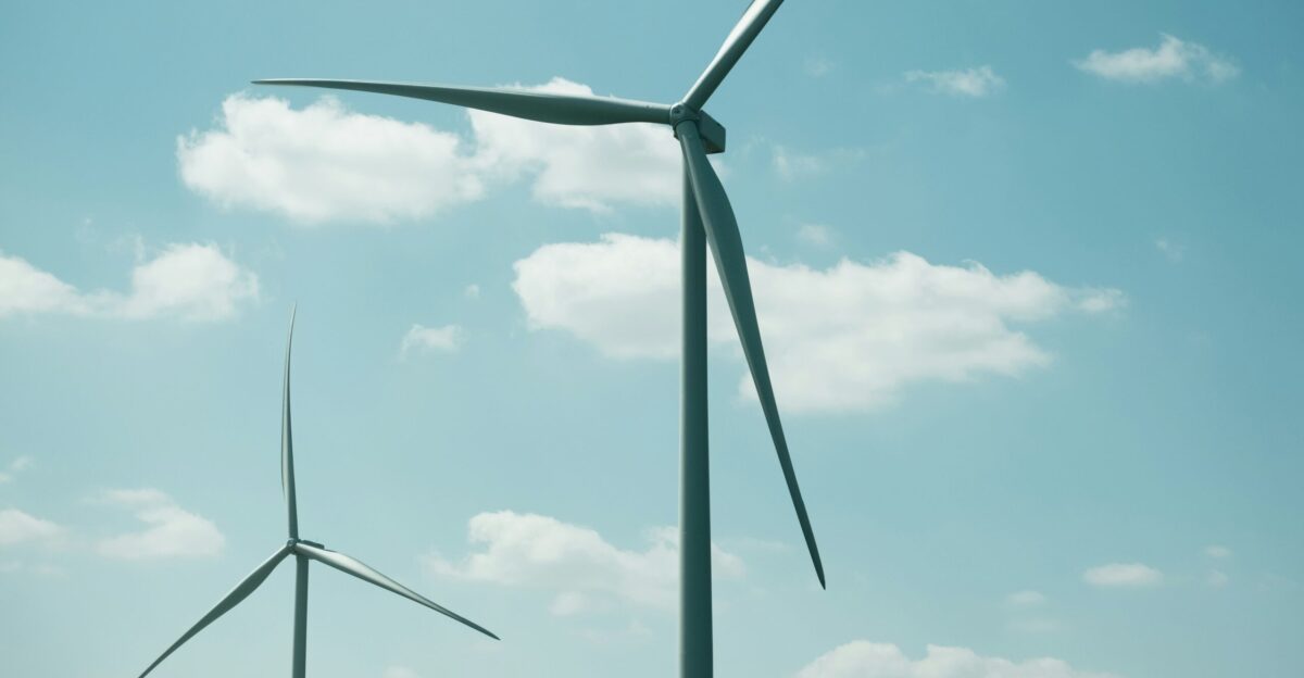 a group of wind turbines against a blue sky