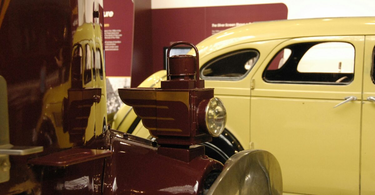 an antique car is on display in a museum