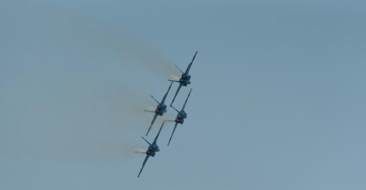 two airplanes flying in the sky with smoke coming out of them