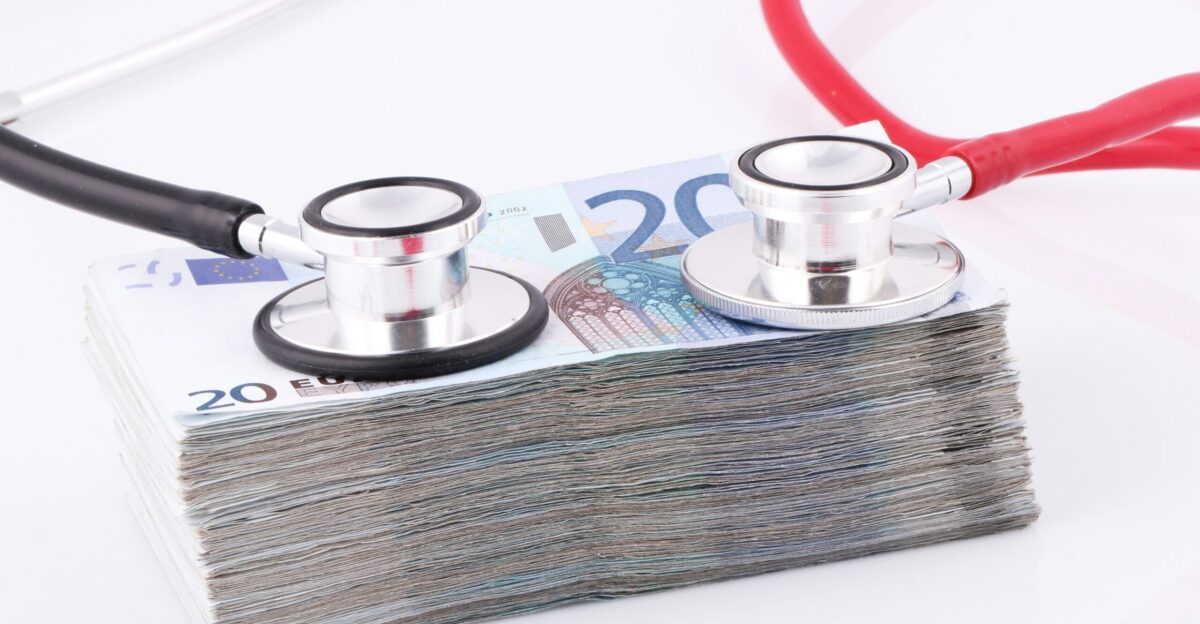 a pile of money with a stethoscope on top of it