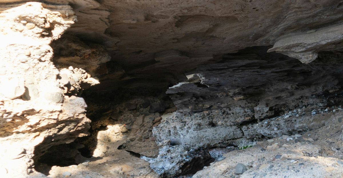 a cave filled with lots of rocks and water