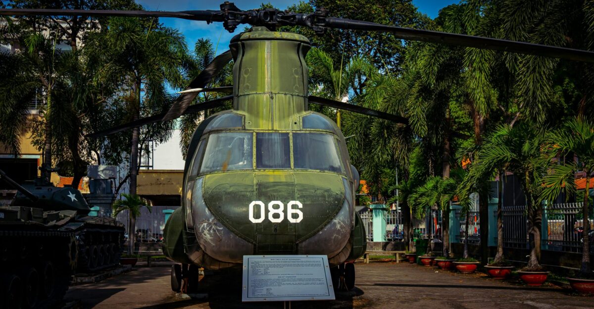 a military helicopter is on display at a museum