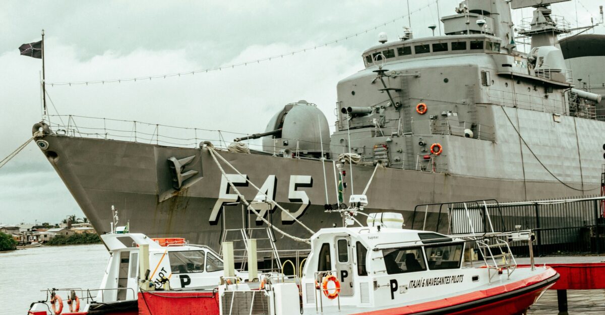 a large ship docked next to a smaller boat