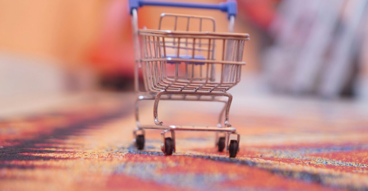 a miniature shopping cart sitting on top of a rug