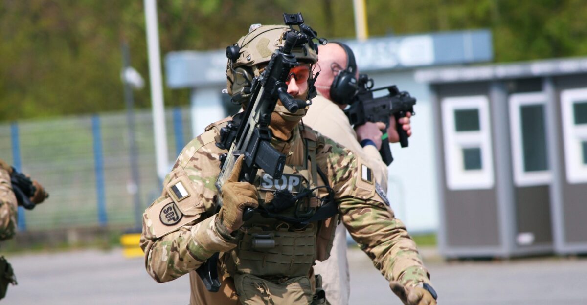 a group of men in military gear walking down a street
